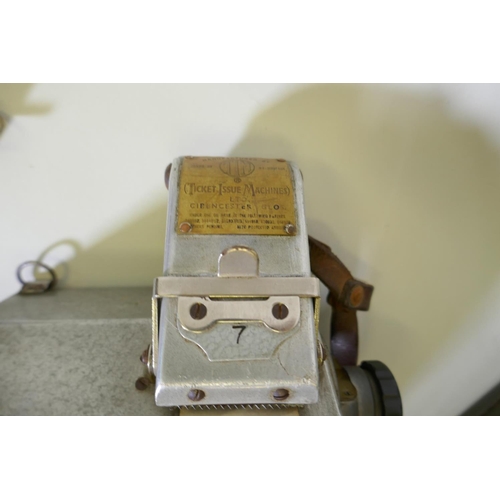 14 - A vintage bus conductors' ticket machine, manufactured by T.M. Ticket Machines Ltd, in metal case, b... 