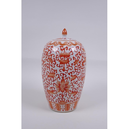 145 - An early C20th Chinese iron red and white porcelain jar and cover with lotus flower decoration, 25cm... 