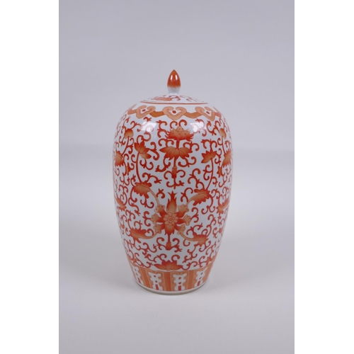 145 - An early C20th Chinese iron red and white porcelain jar and cover with lotus flower decoration, 25cm... 