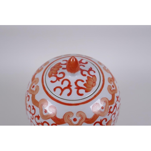 145 - An early C20th Chinese iron red and white porcelain jar and cover with lotus flower decoration, 25cm... 