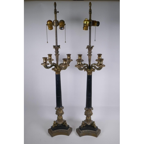 146 - A pair of Empire style bronze and ormolu Corinthian four branch table lamps, 98cm high