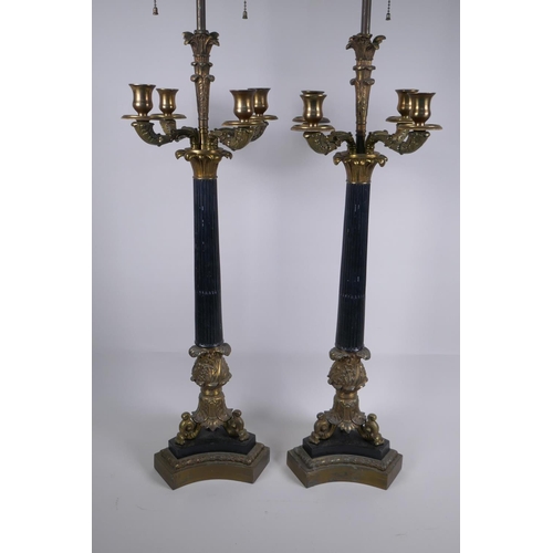 146 - A pair of Empire style bronze and ormolu Corinthian four branch table lamps, 98cm high