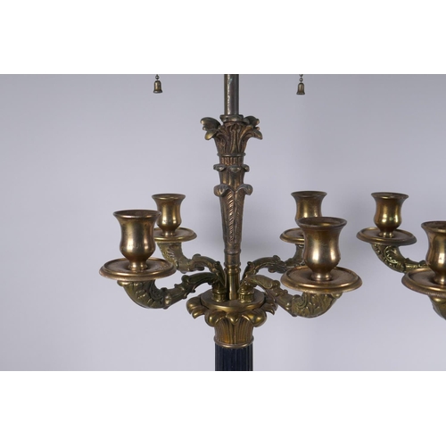 146 - A pair of Empire style bronze and ormolu Corinthian four branch table lamps, 98cm high