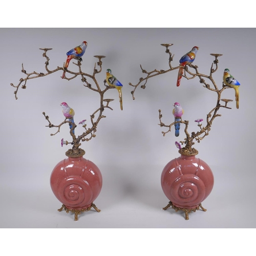 156 - A pair of polychrome porcelain and gilt metal pricket candlesticks decorated with song birds perched... 