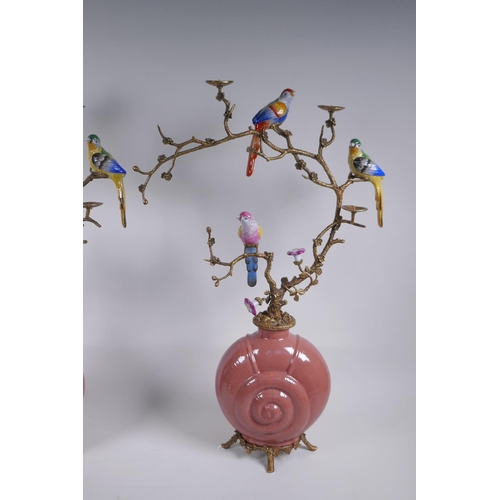 156 - A pair of polychrome porcelain and gilt metal pricket candlesticks decorated with song birds perched... 