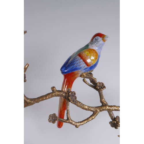 156 - A pair of polychrome porcelain and gilt metal pricket candlesticks decorated with song birds perched... 