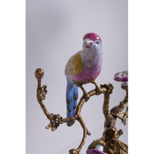 156 - A pair of polychrome porcelain and gilt metal pricket candlesticks decorated with song birds perched... 