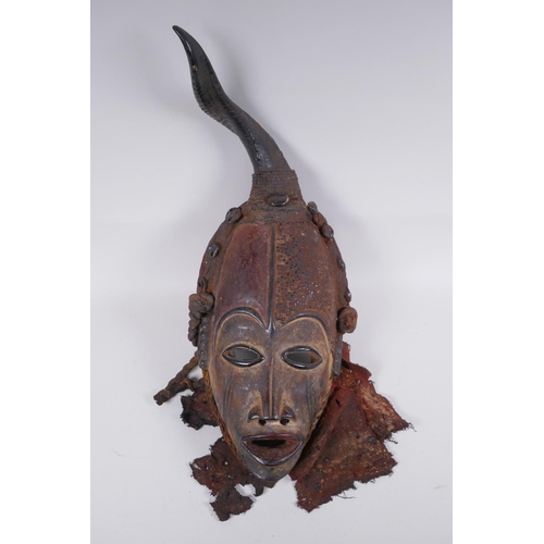 16 - An antique African Igbo tribe carved and painted wood and horn mounted spirit mask, 45cm