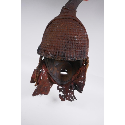 16 - An antique African Igbo tribe carved and painted wood and horn mounted spirit mask, 45cm