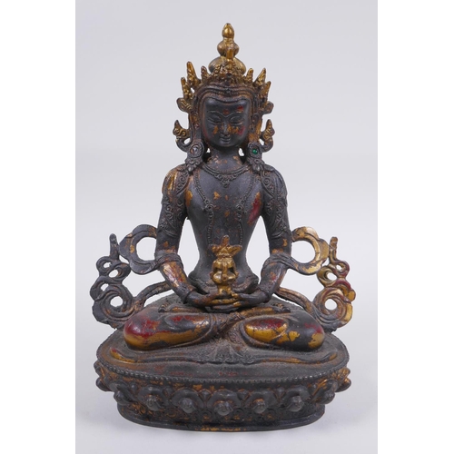 163 - A Sino Tibetan bronze figure of Buddha, with remnants of gilt and copper patina, 22cm high