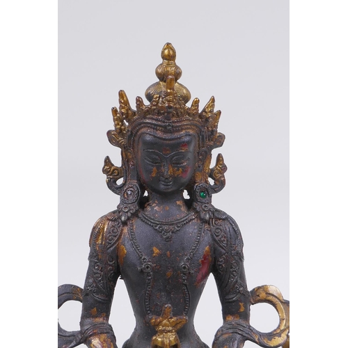 163 - A Sino Tibetan bronze figure of Buddha, with remnants of gilt and copper patina, 22cm high