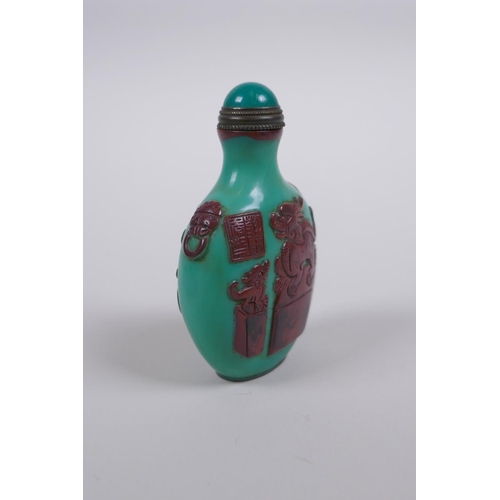 165 - A Peking glass snuff bottle with raised decoration of objects of vitue