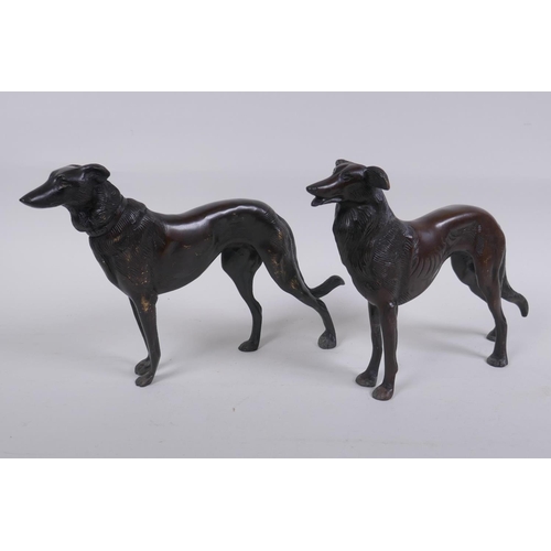 173 - A pair of cast bronze hounds, 25cm long