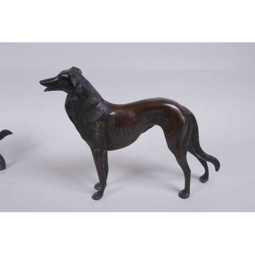 173 - A pair of cast bronze hounds, 25cm long