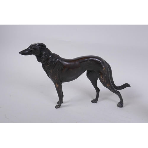 173 - A pair of cast bronze hounds, 25cm long