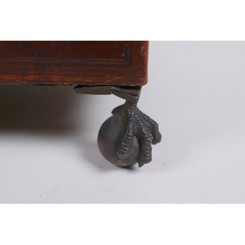 174 - A C19th mahogany tea caddy with banded inlay and brass ball and claw feet, 33 x 18cm 19cm high