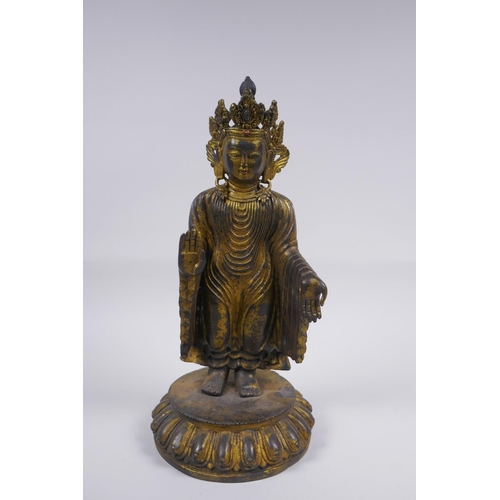 178 - A Sino Tibetan gilt bronze figure of Buddha standing on a lotus flower, 32cm high