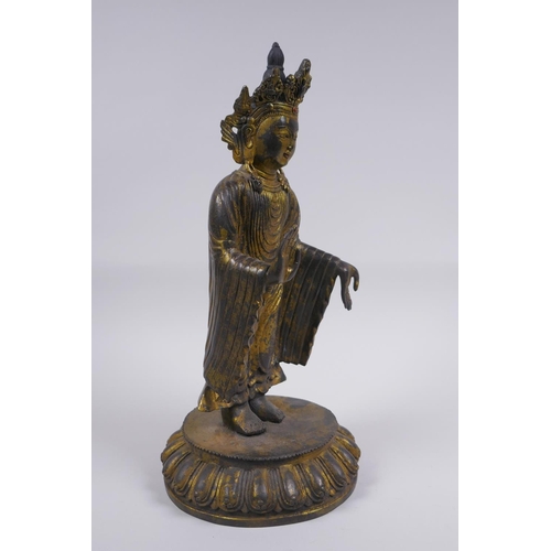 178 - A Sino Tibetan gilt bronze figure of Buddha standing on a lotus flower, 32cm high