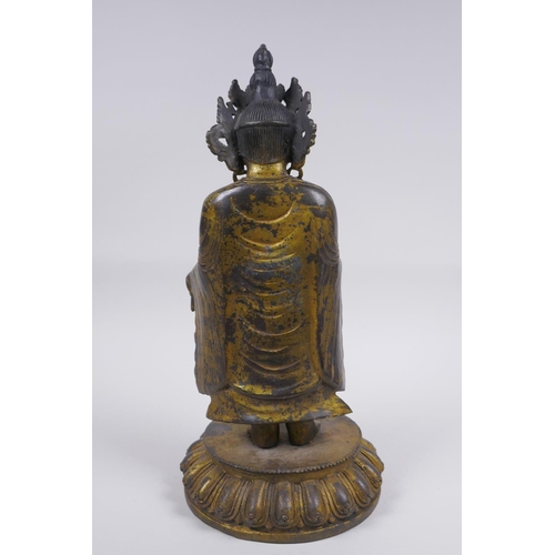 178 - A Sino Tibetan gilt bronze figure of Buddha standing on a lotus flower, 32cm high