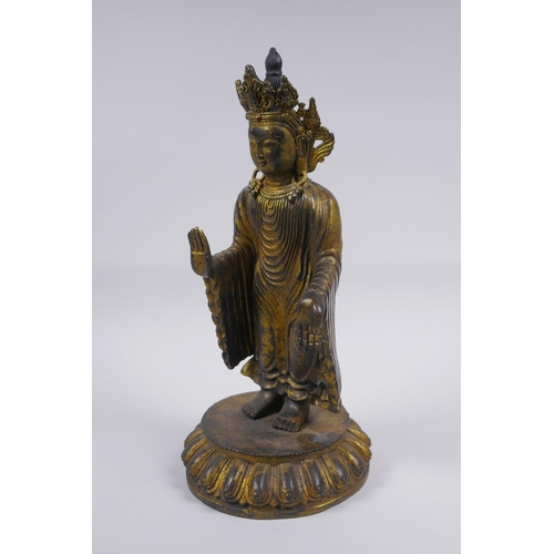 178 - A Sino Tibetan gilt bronze figure of Buddha standing on a lotus flower, 32cm high