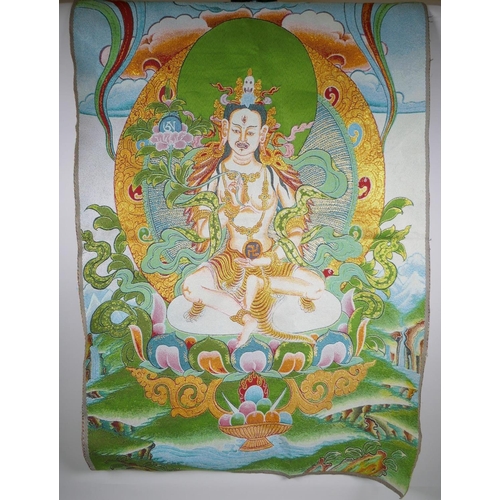 180 - A Tibetan embroidered thangka with gilt thread highlights, 90 x 62cm