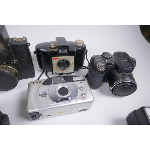 189 - A collection of assorted 35mm, 120mm and digital cameras and accessories including Canon ECS 1000F a... 