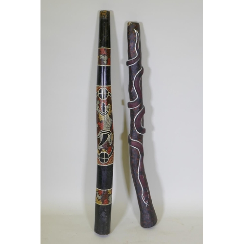 194 - Two carved and painted didgeridoo, longest 126cm