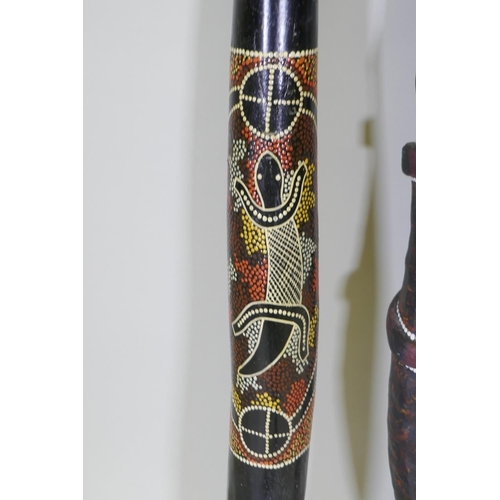 194 - Two carved and painted didgeridoo, longest 126cm