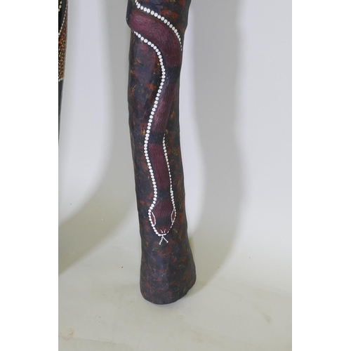 194 - Two carved and painted didgeridoo, longest 126cm