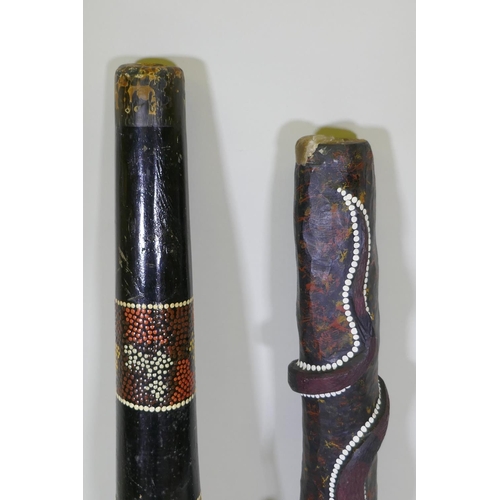 194 - Two carved and painted didgeridoo, longest 126cm