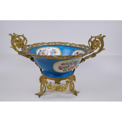 202 - An ormolu mounted Sevres style porcelain centrepiece with decorative panels depicting a courting cou... 