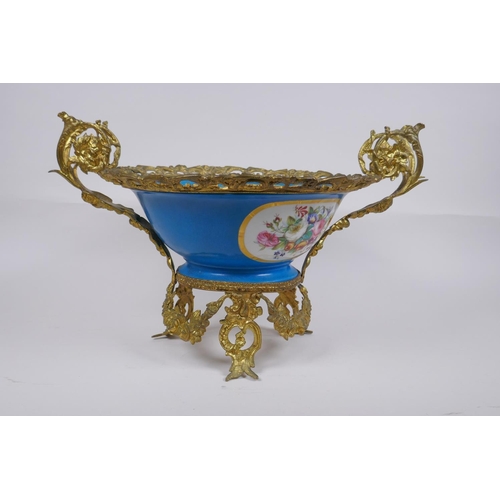 202 - An ormolu mounted Sevres style porcelain centrepiece with decorative panels depicting a courting cou... 