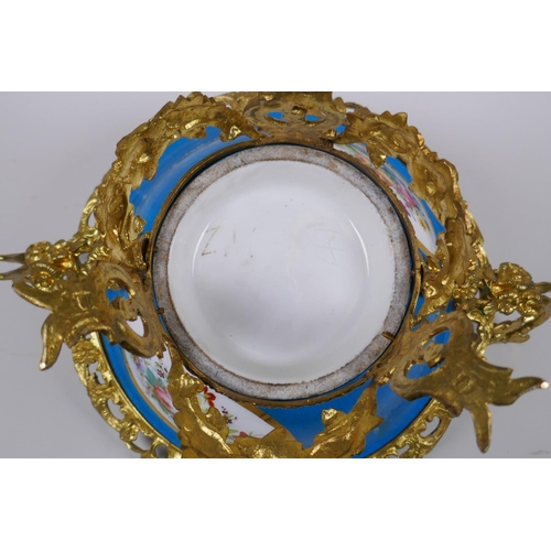 202 - An ormolu mounted Sevres style porcelain centrepiece with decorative panels depicting a courting cou... 