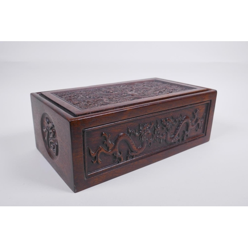 203 - A Chinese carved hardwood box with dragon and character decoration, 28 x 16cm