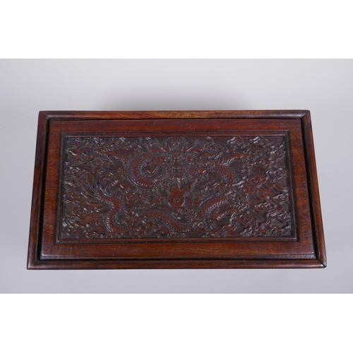 203 - A Chinese carved hardwood box with dragon and character decoration, 28 x 16cm