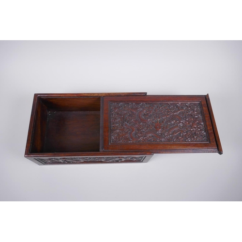 203 - A Chinese carved hardwood box with dragon and character decoration, 28 x 16cm