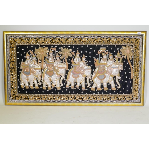 206 - An Indian stumpwork depicting a procession with elephants, mounted in a gilt frame, 82 x 155cm