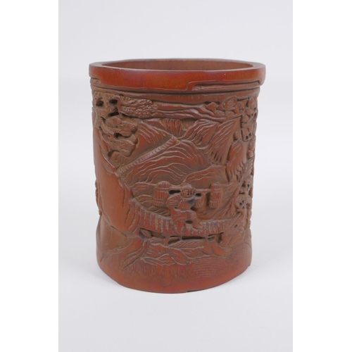 208 - A Chinese carved bamboo brush pot decorated with figures in a landscape, 16cm high