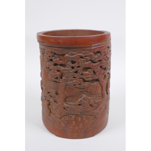 208 - A Chinese carved bamboo brush pot decorated with figures in a landscape, 16cm high