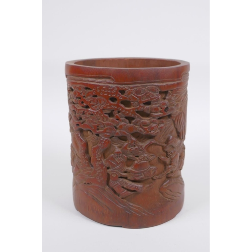 208 - A Chinese carved bamboo brush pot decorated with figures in a landscape, 16cm high