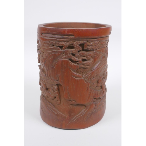 208 - A Chinese carved bamboo brush pot decorated with figures in a landscape, 16cm high