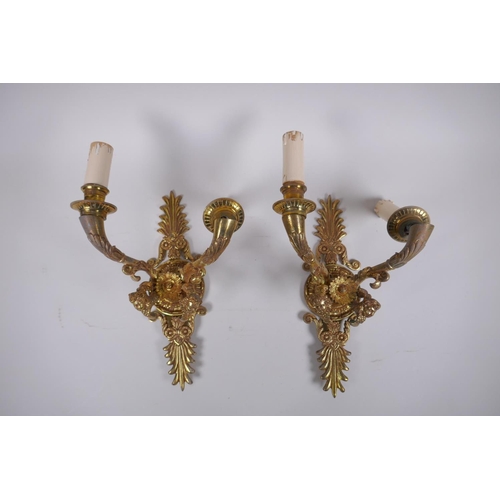 212 - A pair of ormolu two branch wall sconces with putti mask decoration, 30cm high