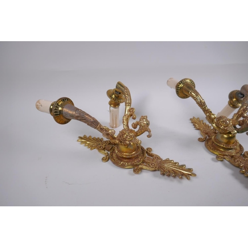 212 - A pair of ormolu two branch wall sconces with putti mask decoration, 30cm high