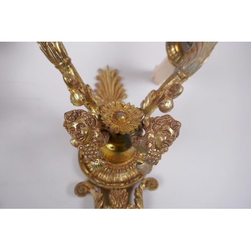 212 - A pair of ormolu two branch wall sconces with putti mask decoration, 30cm high