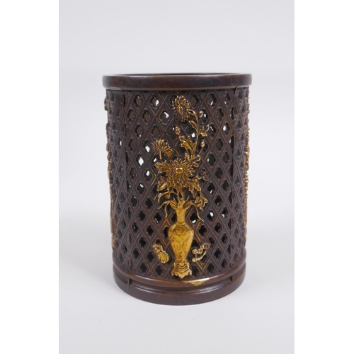 213 - A Chinese pierced bronze brushpot decorated with flowers in vases highlighted with gilt, 12cm high x... 