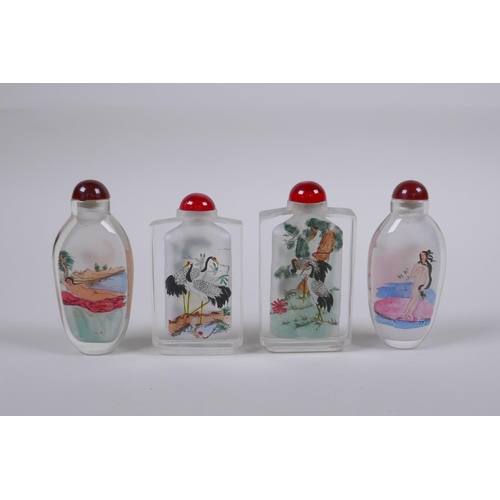 215 - A pair of Chinese reverse decorated glass snuff bottles depicting European nudes, together with anot... 