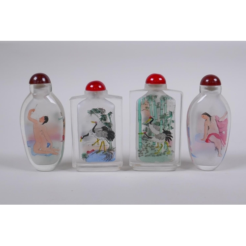 215 - A pair of Chinese reverse decorated glass snuff bottles depicting European nudes, together with anot... 