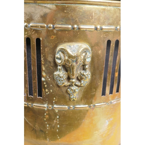 217 - An antique brass coal scuttle with two lion mask loop handles, rams mask decoration and pawed feet, ... 