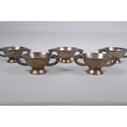 218 - A set of five Chinese silvered metal cups/bowls with two dragon handles, 10 cm diameter