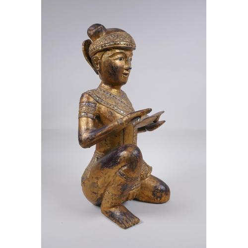 221 - A Tibetan carved gilt and painted wood figure of a musician with inset glass decoration, 38cm high, ... 